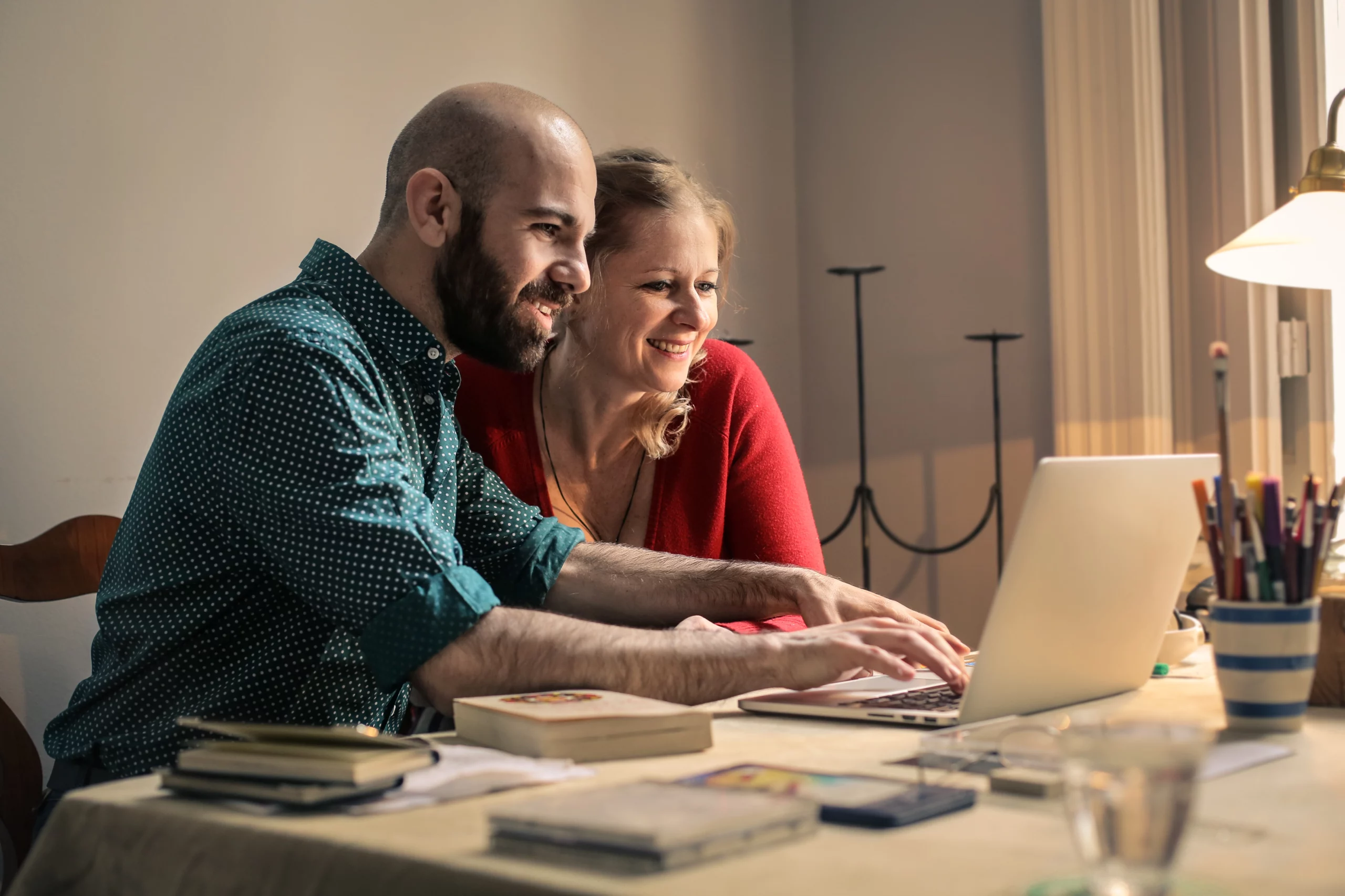 Man and Woman Looking at A Laptop