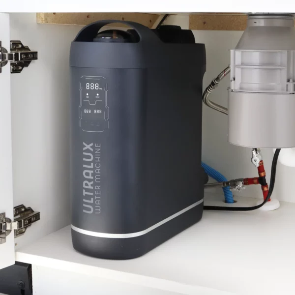 The best reverse osmosis water filter, the UltraLux Water Machine, connected to water lines under the sink.