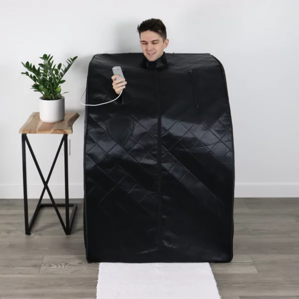 A man adjusts the temperature while inside the UltraLux Foldaway Sauna from UltraLux Health.