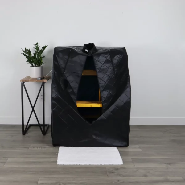 The UltraLux Foldaway Sauna sitting unzipped in a living room.