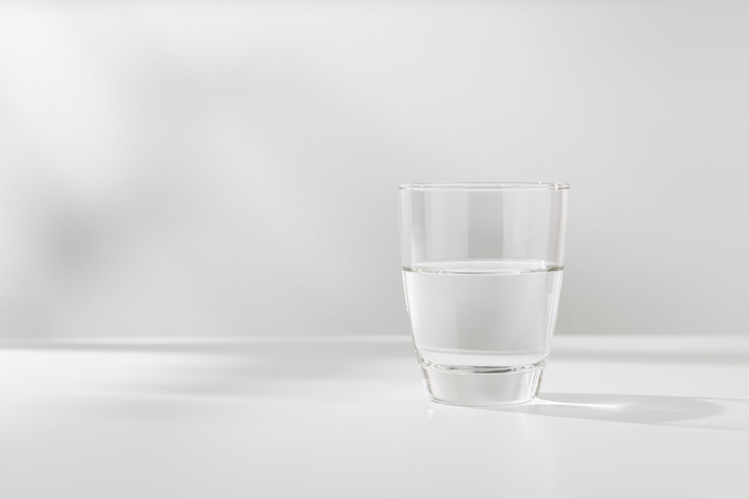 Cup of water on white background
